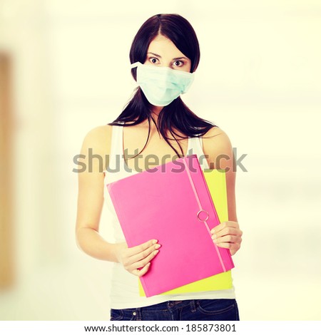 Caucasian student woman with mask on her face. She is defending her self from viruses.
