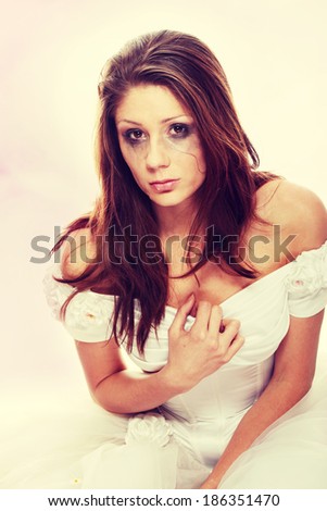 Beautiful young caucasian sad bride crying, over white background