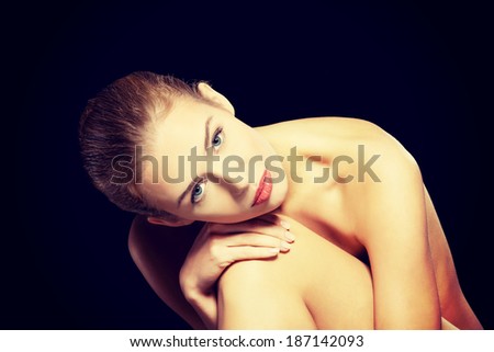 Portrait of beautiful topless caucasian woman. Spa concept. On black backround.
