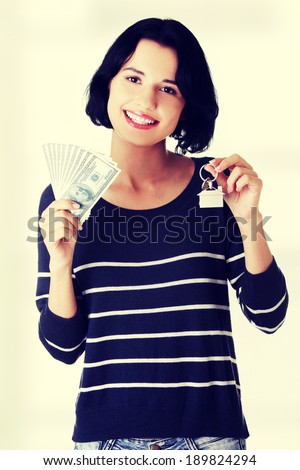 Beautiful young woman holding US dollars bills and house model  - real estate loan concept