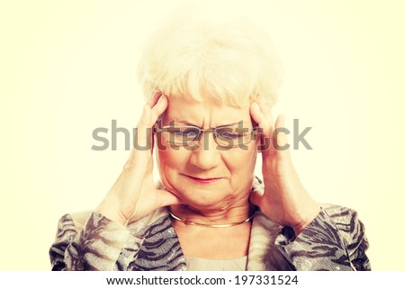 An old elegant lady is having a headache
