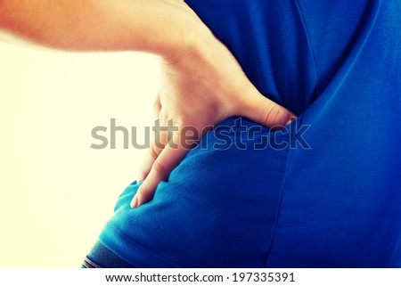 Casual woman is having a back pain. Close up.