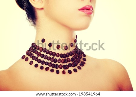 Beautiful elegant young woman with necklace made frome coffee beans