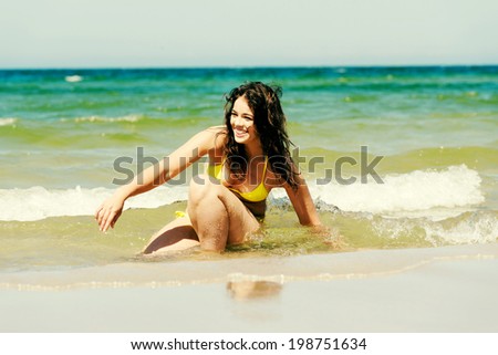 Happy summer woman playing by the sea or ocean on vacation.