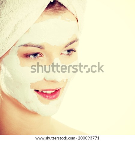 Cosmetics mask of clay on the beautiful young female face.