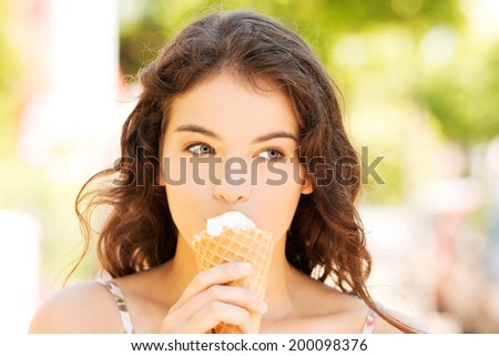 Young happy woman eating ice-cream