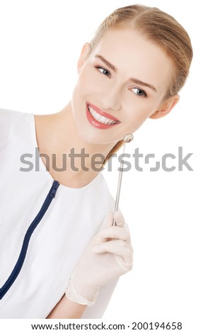 Young dentist with small mirror to checking up teeth. Isolated on white.