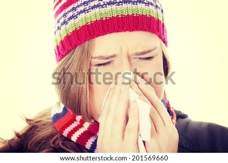 Sneezing woman with handkerchief, close up.