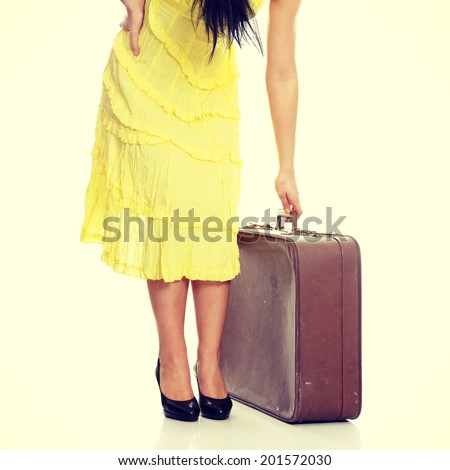 Caucasian woman legs with travel case.