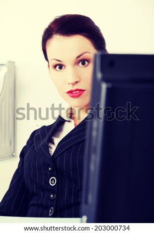 A photo of shocked business woman, in office.