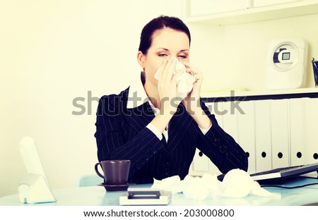 Young woman is sneezing. Illness concepion.