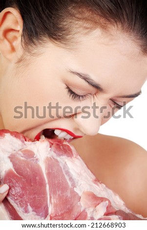 Young beautiful woman eating raw meat. Isolated on white