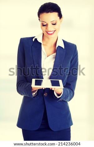 Attractive business woman using digital tablet computer PC, isolated on white background.