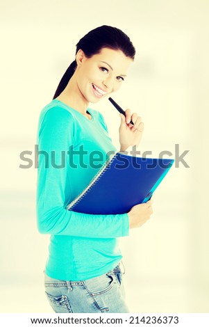 Happy student woman with notebook, isolated on white background