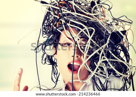 Troubled shocked businesswoman with cables on head