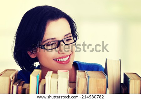 Happy smiling young student woman with books, isolated on white background
