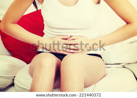 A photo of woman with stomach ache. Illness concepion.