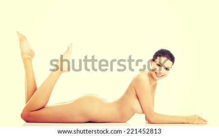 Sexy fit naked woman with healthy clean skin lying down.