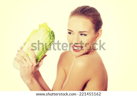 Beautiful topless caucasian woman with iceberg lettuce. Isolated on white.