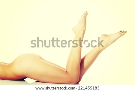 Shaved and smooth woman\'s long legs. Isolated on white.