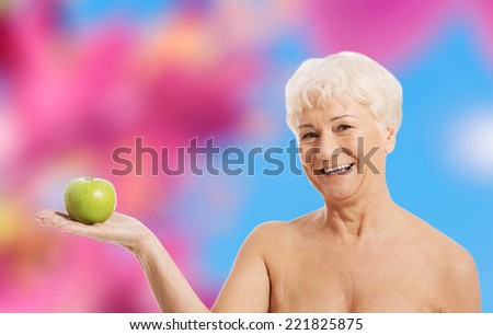 60 years old happy woman holding and apple