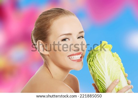 Beautiful topless caucasian woman with iceberg lettuce
