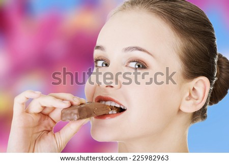 Beautiful woman eating chocolate waffle