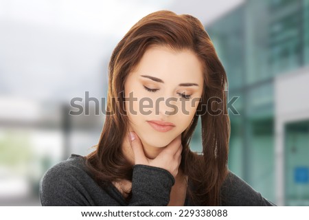 Charming young woman with terrible throat pain