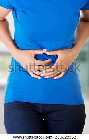 Woman heaving huge belly ache