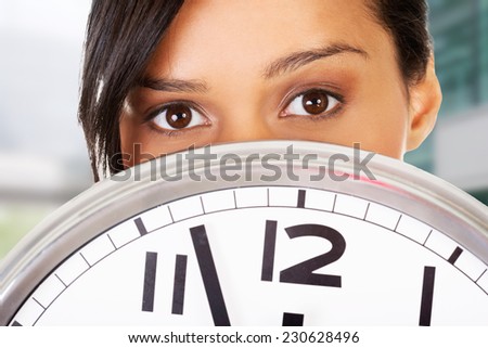 Portrait of shocked woman with clock.