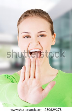 Hold on, Stop gesture showed by young woman.
