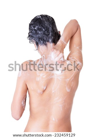 Back view of young sexy woman with soap foam.
