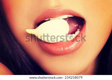 Young beautiful woman eating garlic. Healthy eating concept. Natural antibiotic that fight infection