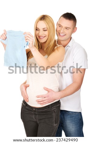 Pregnancy couple with small baby blue shirt