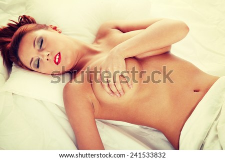 Pretty sexy topless woman on the bed.