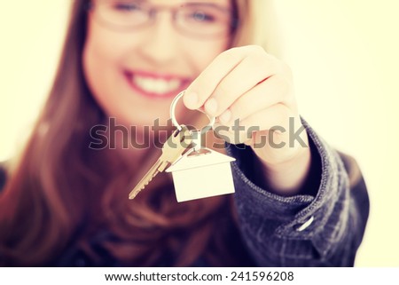 Young businesswoman ,real estate agent, with house keys in hand