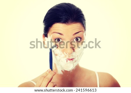 Young woman have morning shave.