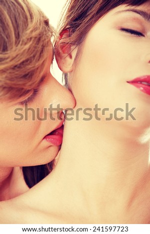 Sensual couple close up while kissing in neck
