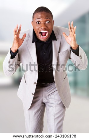 Young angry black businessman screaming