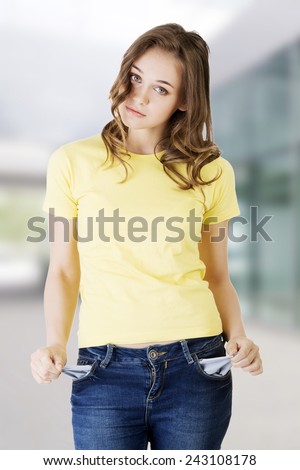 Sad young caucasian teen girl taking out empty pockets.