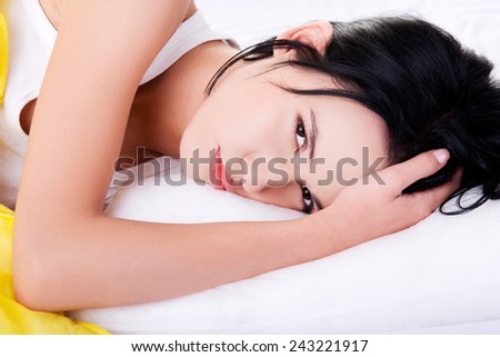 Young lazy woman lying in bed.