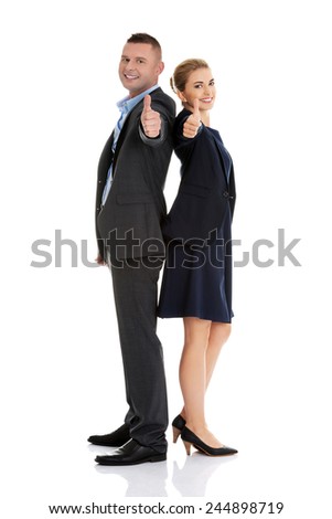 Business couple showing thumbs up.