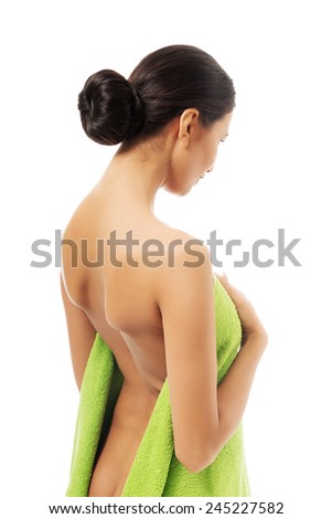 Woman wrapped in towel back to the camera.