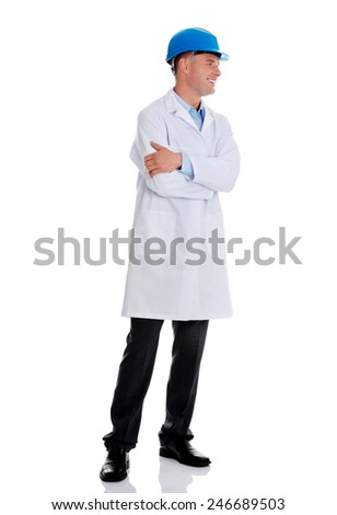 Man in a lab coat and helmet, engineer, teacher or chemical looking on copy space