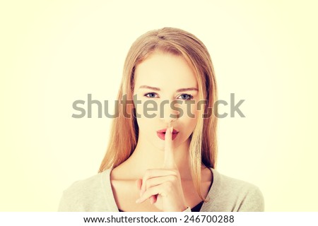 Beautiful caucasian woman with finger on lips.
