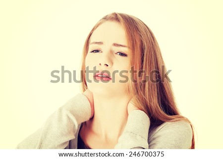 Beautiful casual woman suffering from neck pain.