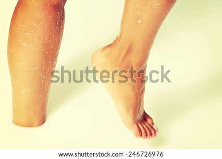 Female wet feet in a bath- milk. Close up.