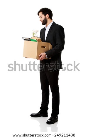 Fired businessman holding box with personal belongings.