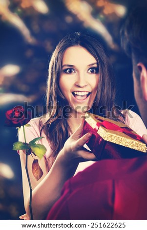 Shocked woman recieving a gift on Valentines Day.