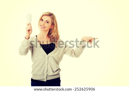 Green energy concept. Woman with led light bulb showing copy space.